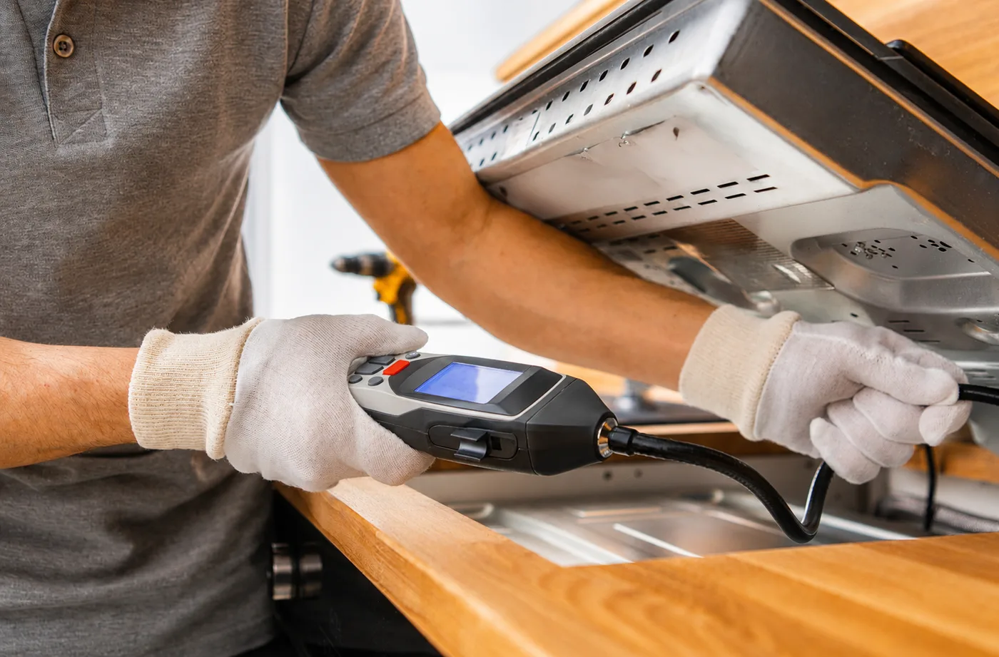 Inspection camera checking for a leak under a kitchen counter