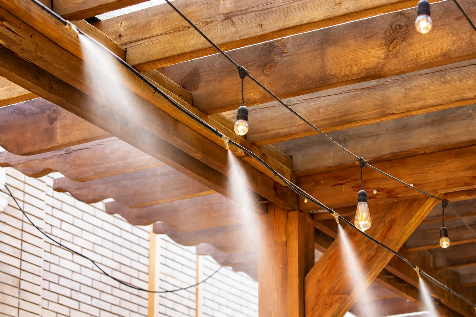Patio misting system cooling a pergola