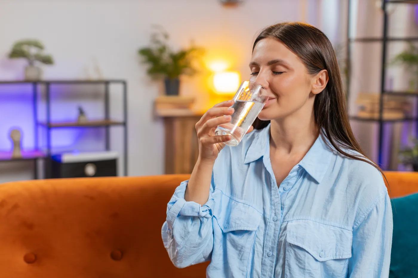 Homeowner drinking filtered water at home