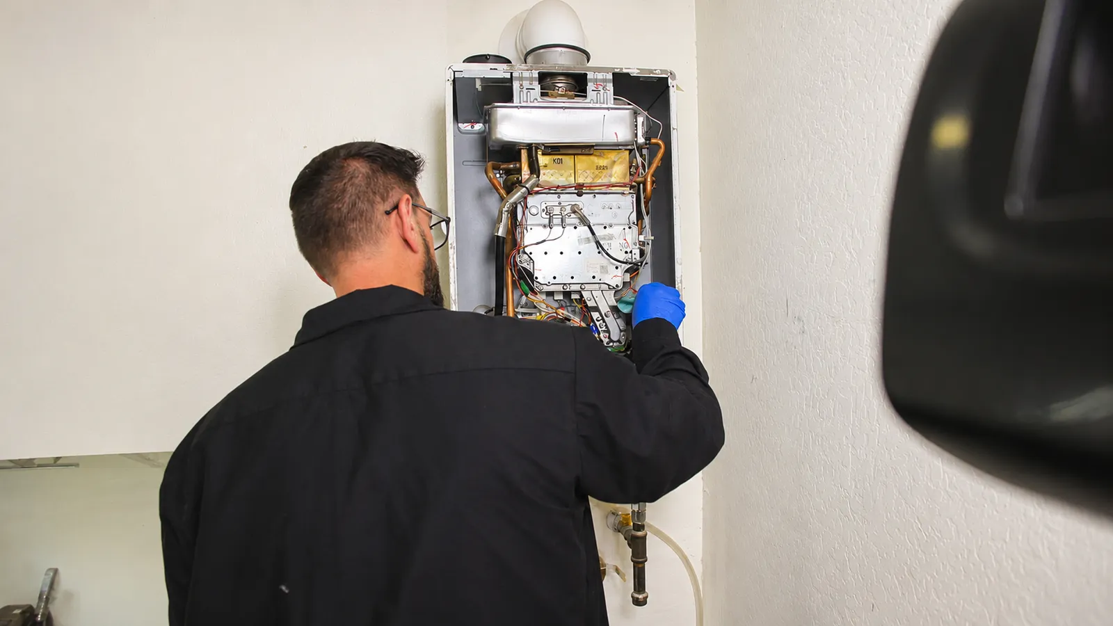 Technician servicing a tankless water heater